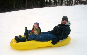 man sledding with a baby