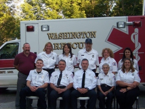 people in front of an ambulance