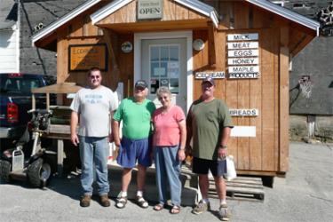 Three generations of Eccards in front of their Farm Store - Ryan, Hans, Julia and George